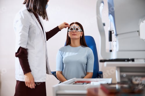 Preview: Eye physician making a horizontal adjustment of a trial frame