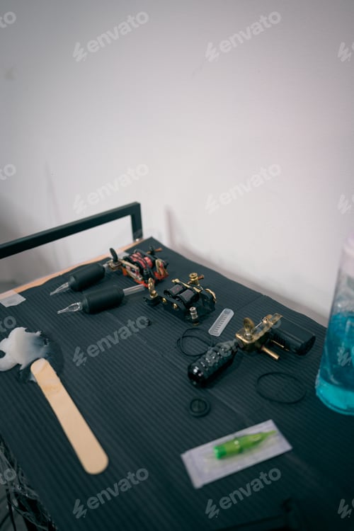 Preview: Close-Up View of Tattoo Equipment on Black Workstation in a Tattoo Parlor