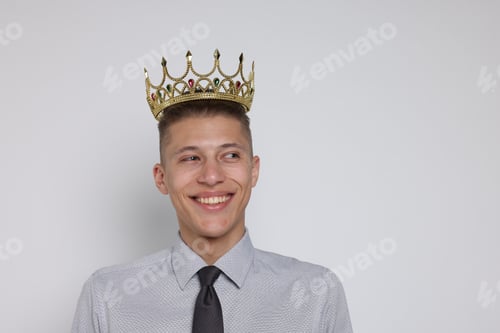 Preview: Handsome man wearing luxury crown on white background, space for text