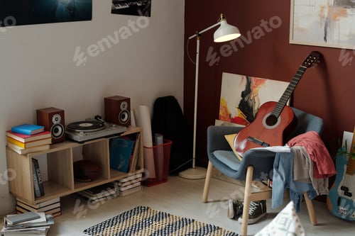 Preview: New acoustic guitar standing on armchair