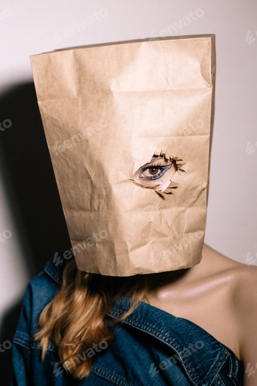 Preview: Creative Portrait Of A Beautiful Girl With A Package On Her Head Against The Background Of A White