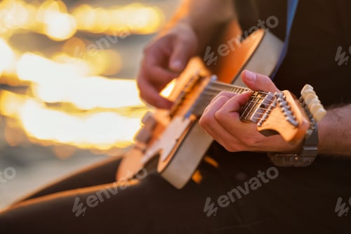 Preview: Street musician playing electric guitar hands close up