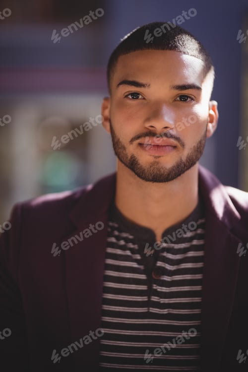 Preview: Portrait of confident young man wearing maroon blazer