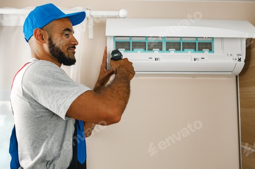 Preview: Professional repairman installing air conditioner in a room