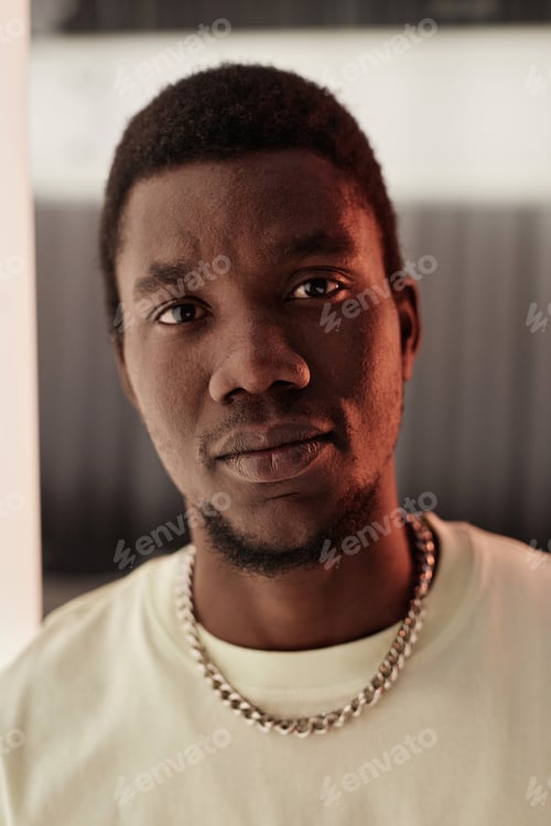 Preview: Close Up Young Black Man Looking at Camera with Serious Face Expression