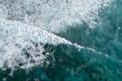 Preview: aerial view of surfers catching a wave at Bronte beach in Australia, view from above