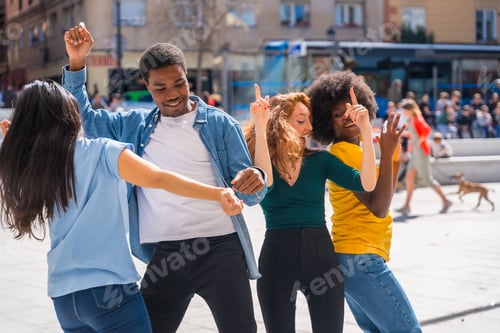 Preview: Multi ethnic young friends dancing in a city square, authentic group of diverse friends having fun