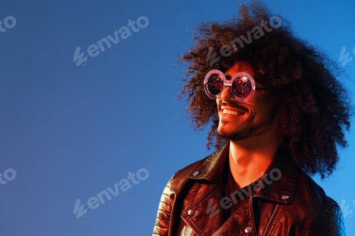 Preview: Portrait of a stylish man with curly hair with glasses smile on blue background multinational, color