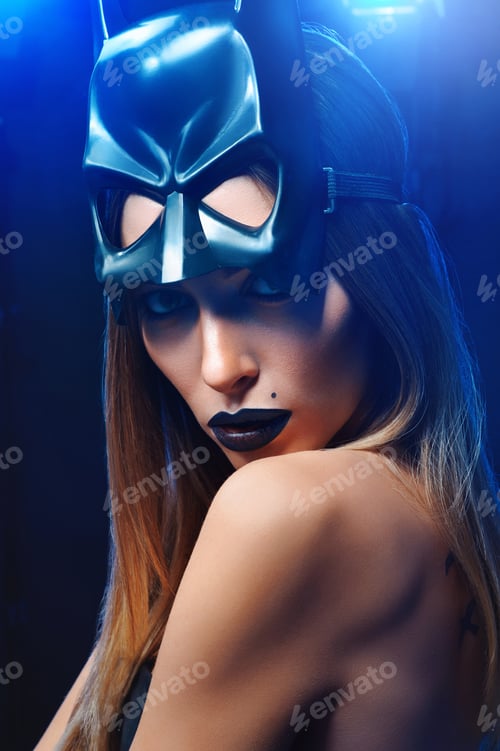 Preview: Beautiful woman wearing professional makeup and batman mask