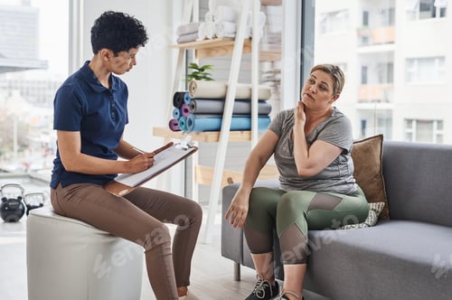 Preview: Shot of a young physiotherapist consulting with a mature woman inside her office at a clinic