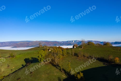 Preview: Misty morning in the mountains. Aerial drone view of abandoned hut and homestead