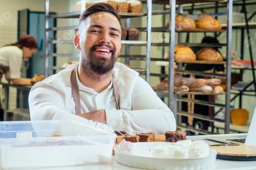 Preview: Cheerful baker delivering bread to client in store