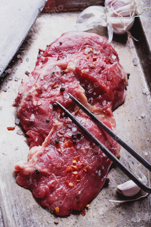 Preview: Fresh Raw Steak Seasoned with Pepper and Garlic