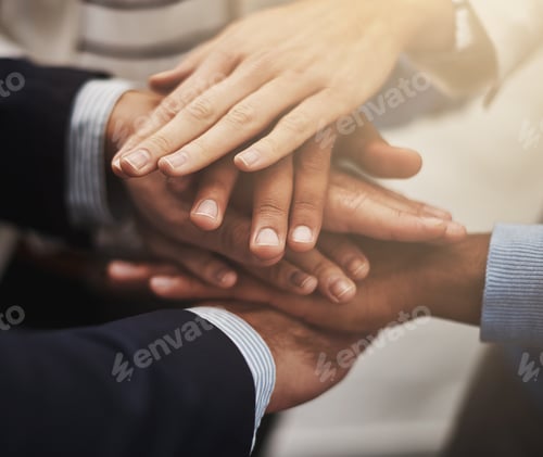 Preview: Cropped shot of a group of businesspeople putting their hands together in unity