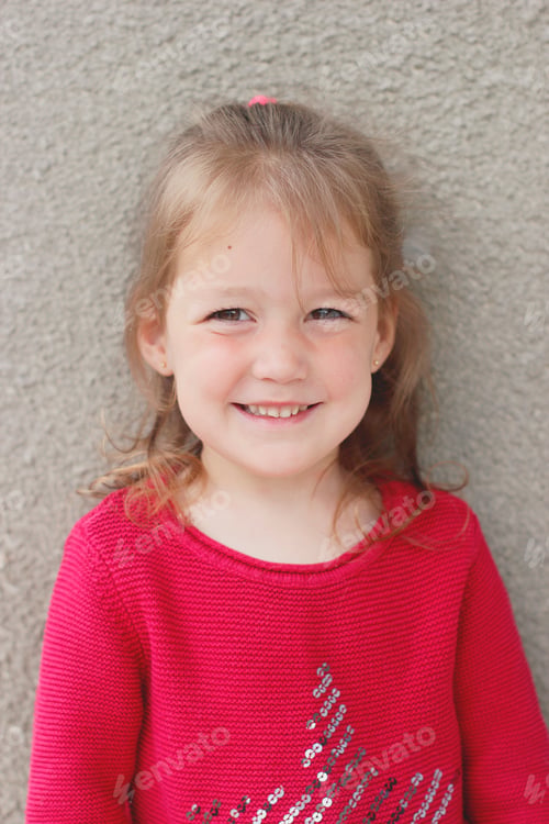 Preview: Sweet little girl looking at camera and funny smiling