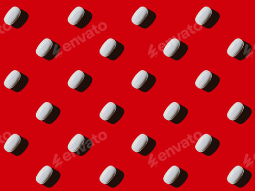 Preview: close-up view of pattern made from white capsules on red