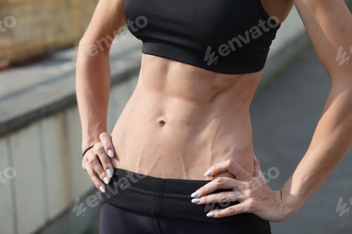 Preview: athletic woman in sportswear outdoor on urban street