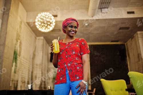 Preview: Stylish african woman in red shirt and hat