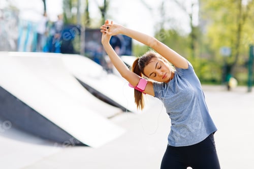 Preview: Young woman having exercise in the park