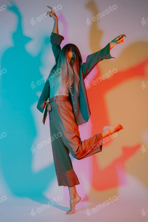 Preview: Woman expressing body language in colored studio light