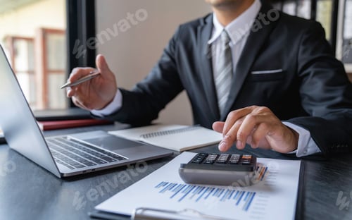 Preview: Asian male accountant or banker making calculations. Savings, finances and economy concept through a