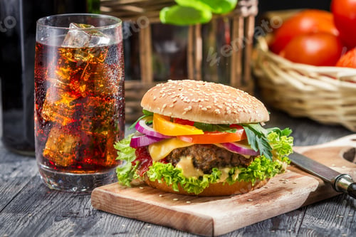 Preview: Closeup of homemade hamburger and a Coke with ice