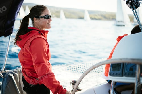 Preview: Attractive strong woman sailing with her boat