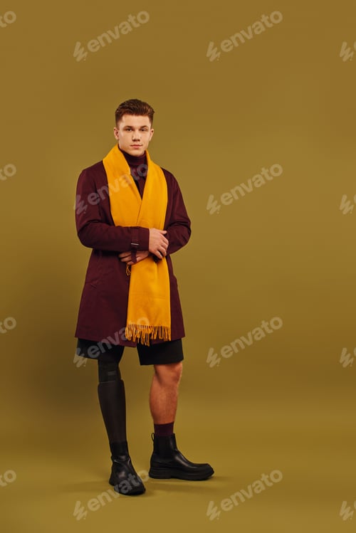 Preview: Handsome young man with prosthetic leg showcases trendy fashion in studio setting