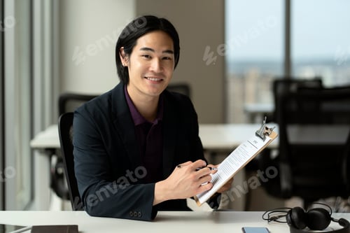 Preview: Entrepreneur reading contract, sings documents working in modern office. Successful business