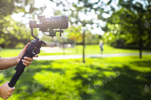 Preview: A girl operating camera mounted on a gimbal, focus on the gimbal and camera.