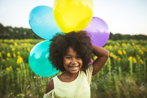 Preview: Pretty afro american girl in a sunflowers field