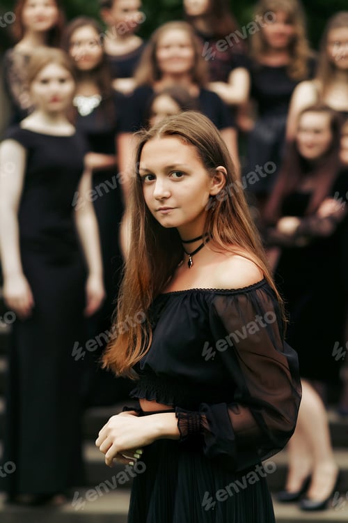 Preview: luxury gorgeous woman in black dress posing, standing in front of group of ladys