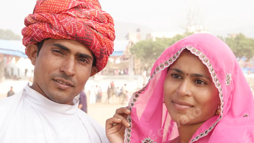 Preview: Closeup of an Indian couple in traditional outfits outdoors.