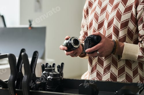 Preview: Man Assembling Camera Lens in Professional Studio