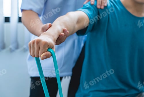 Preview: Physical therapist gives resistance band exercises. About the arms and shoulders of male office work