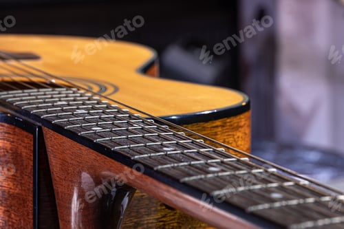 Preview: Close-up of a guitar fretboard on a blurred background.