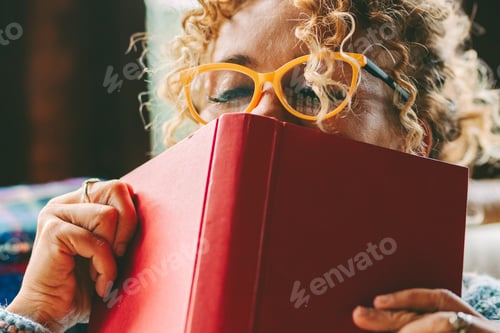Preview: Woman relax and pleasure expression about reading a book novel alone at home. Happiness and joyful