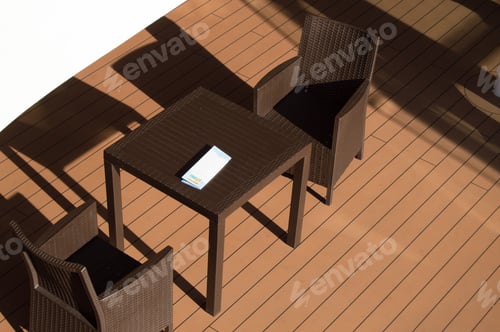 Preview: Dark table and chairs of the restaurant on the open deck of the cruise ship, top view
