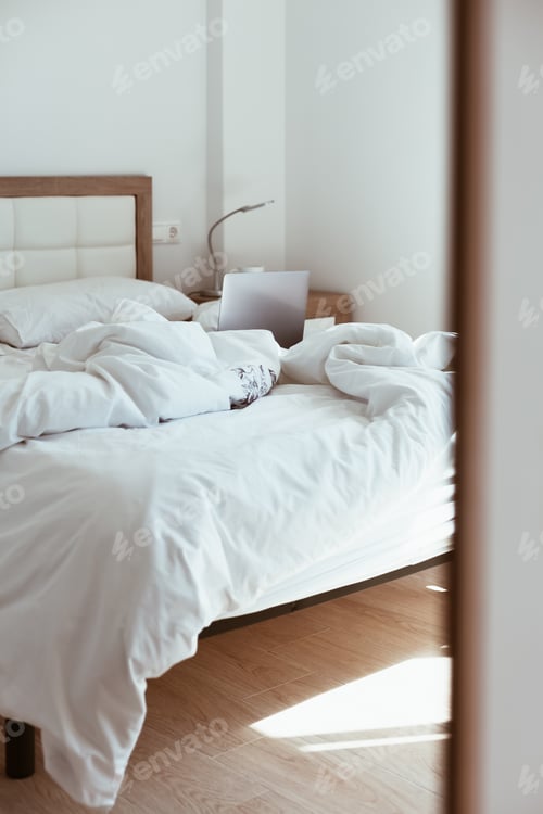 Preview: Working home isolation concept. Laptop in bed