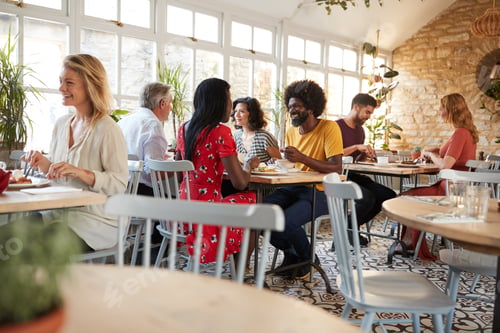 Preview: Customers eating at a busy restaurant in the day time