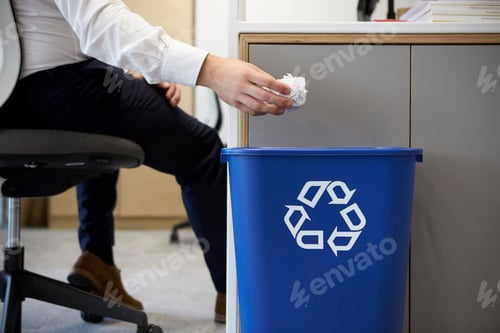 Preview: Man dropping screwed up paper into recycling bin, close up