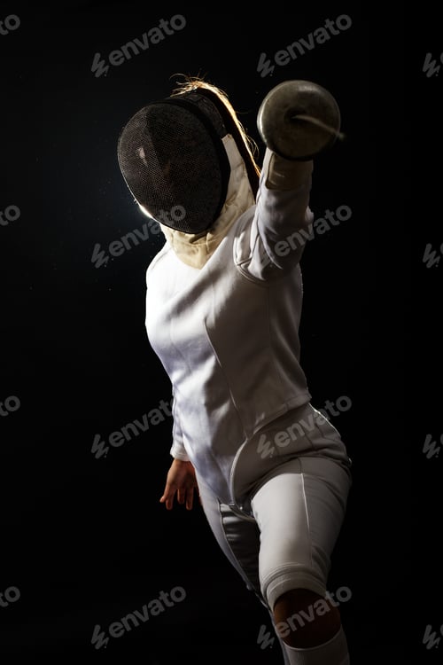 Preview: Portrait of woman wearing white fencing costume practicing with the sword.