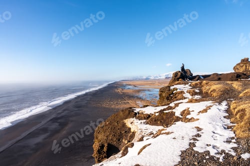 Preview: Young woman on the viewing platform on top of Mount Dyrholaey in Iceland