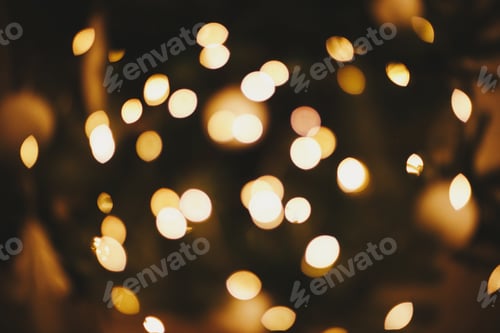Preview: Golden Christmas lights bokeh. Christmas abstract background, glowing illumination. Happy holidays!