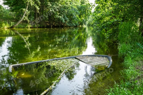 Preview: Damaged boat sunk by the river