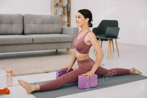 Preview: Attractive and healthy young woman sat down on the twine at home