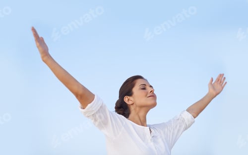 Preview: Feel the freedom. A young woman standing with her arms outstretched.
