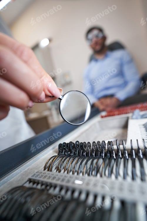 Preview: Ophthalmologist getting optical lens out of box