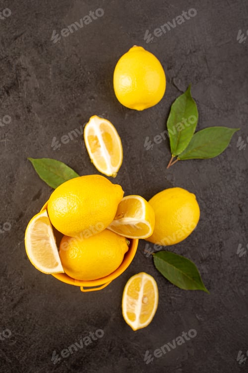 Preview: a top view yellow fresh lemons mellow and juicy whole and sliced inside yellow basket spread with