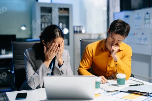 Preview: A stressed business team working late at night, facing deadlines and financial issues in the office.